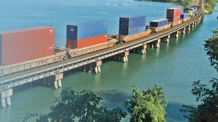 TTX railcars on a elevated track over water